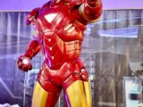 a statue of iron man is displayed in a museum