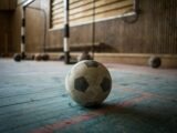 white and black soccer ball on blue surface