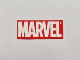 a red and white sticker with the word marvel on it