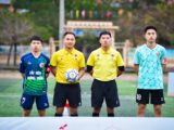 Football players and referees posing before a match in Hanoi, Vietnam.