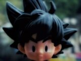 A close up of a toy of a boy with black hair