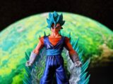 Blue-haired anime figure with glowing energy and planet background