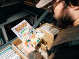 Man looking at a spidey comic book in a bin