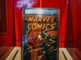 a comic book on display in a glass case
