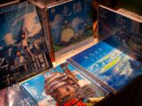 Collection of anime books featuring studio ghibli artwork.