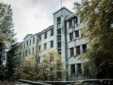 A haunting scene of an abandoned concrete building enveloped by dense foliage, depicting urban decay.