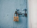 brown padlock on blue wooden door