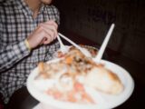 person holding white ceramic plate with food