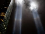 a very tall building with two beams of light coming out of it