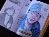 Open book displaying manga panels with character portraits.