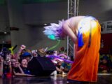 Cosplayer bows to cheering crowd at convention