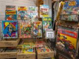 a bunch of comics are on display in a store