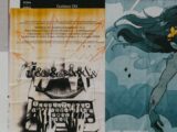 a couple of posters on a wall next to each other