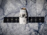 SpaceX Dragon spacecraft in orbit, highlighting advanced space technology with cloud backdrop.
