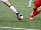 a couple of men playing a game of soccer