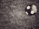 black and yellow soccer ball on green grass field