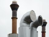 a group of metal pipes with a sky in the background