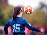 girl in blue and white nike soccer jersey shirt