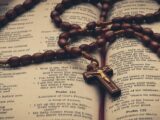 a rosary on top of an open Bible