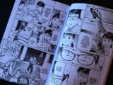Open comic book with panels and dialogue bubbles