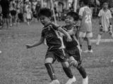 a couple of kids playing a game of soccer
