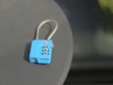 A small blue combination lock rests on a surface.