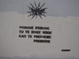 Graffiti with eyes and text on a wall