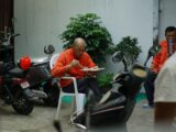 a man sitting on a chair eating a plate of food