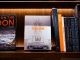 a book shelf filled with books and a space shuttle