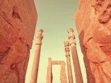 A couple of tall stone pillars sitting next to each other