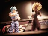 a figurine of gohan and a laptop on a desk