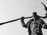 man in black and white jacket holding black metal bar