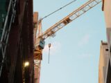 A construction crane dominates the urban skyline of Bratislava, Slovakia.